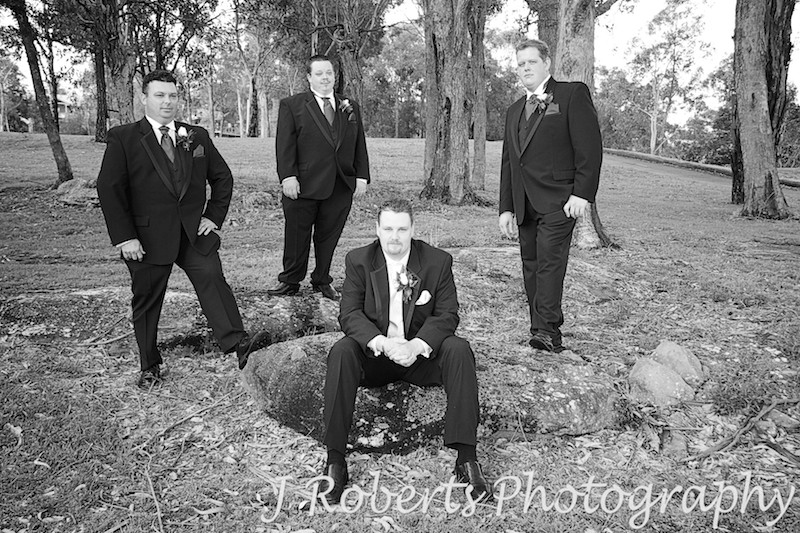 Sepia groom and groomsmen looking serious - wedding photography sydney